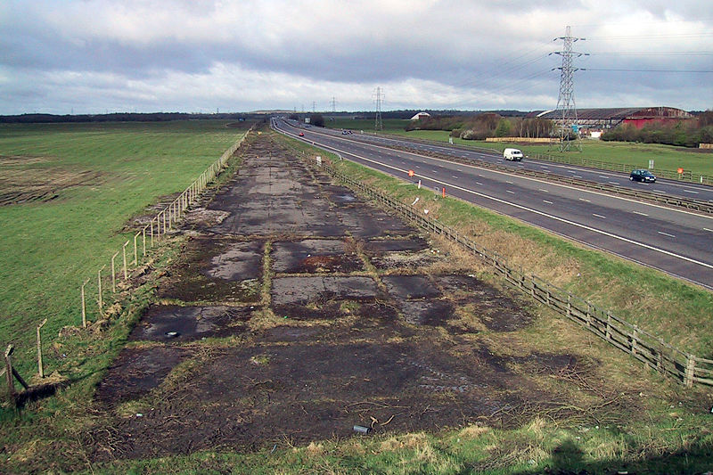 View westbound at the site of M62 J8, showing the last remaining part of the Burtonwood main runway before construction of the junction (Author - Paypwip, Wikipedia. Republished under the Creative Commons License)